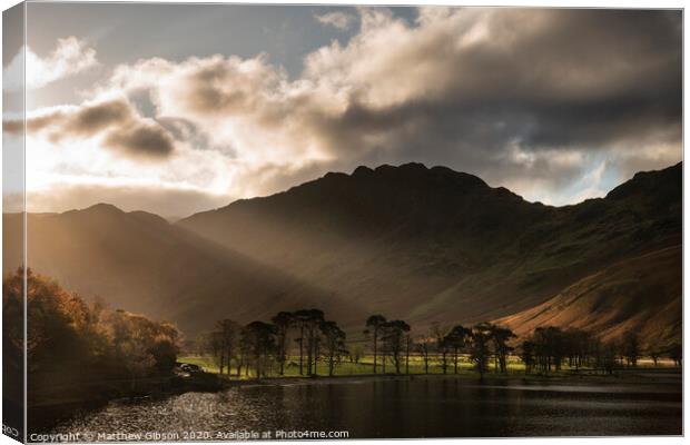 Majestic vibrant Autumn Fall landscape Buttermere in Lake District with beautiful early morning sunlight playing across the hills and mountains Canvas Print by Matthew Gibson