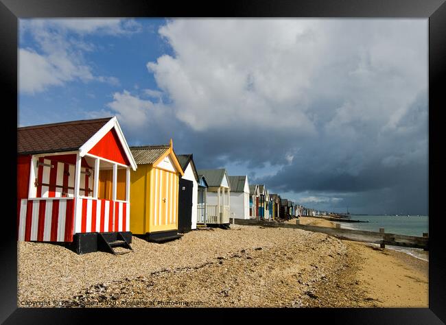Vibrant Beach Huts Bracing for a Storm Framed Print by Peter Bolton