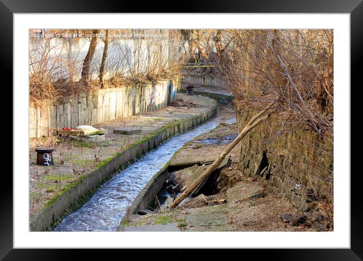 The dirty river Lybid flows along a channel enclosed in a concrete chute. Framed Mounted Print by Sergii Petruk