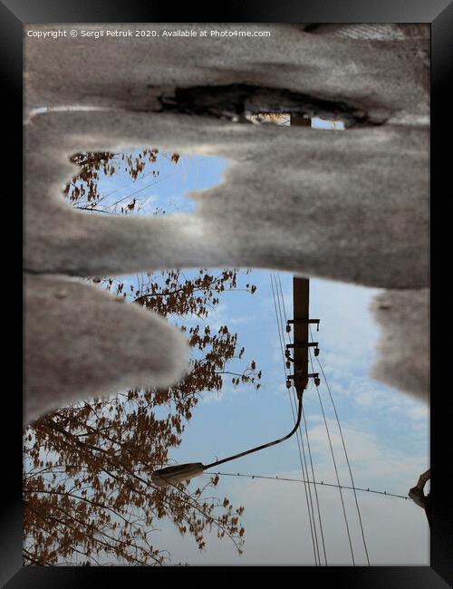 Reflection of the sky, the silhouette of a street lamp and a tree in a puddle on bad asphalt. Framed Print by Sergii Petruk