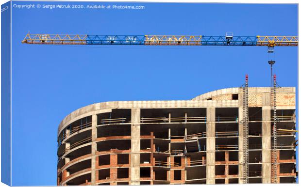 Facade and construction crane near the modern concrete building under construction. Canvas Print by Sergii Petruk