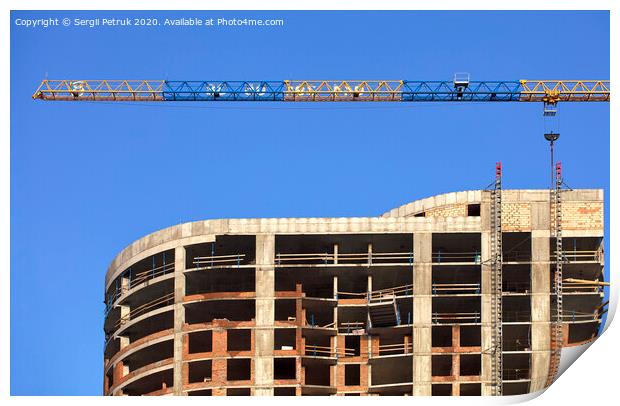 Facade and construction crane near the modern concrete building under construction. Print by Sergii Petruk