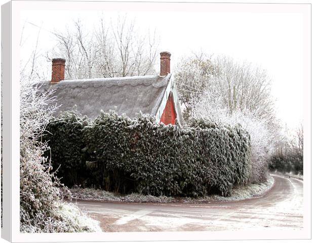Thatched cottage after a heavy frost Canvas Print by Karen Steel
