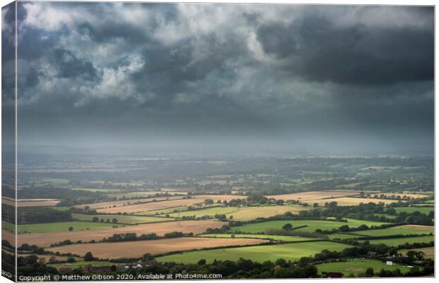 Stunning Summer landscape image of escarpment with dramatic storm clouds and sun beams streaming down Canvas Print by Matthew Gibson