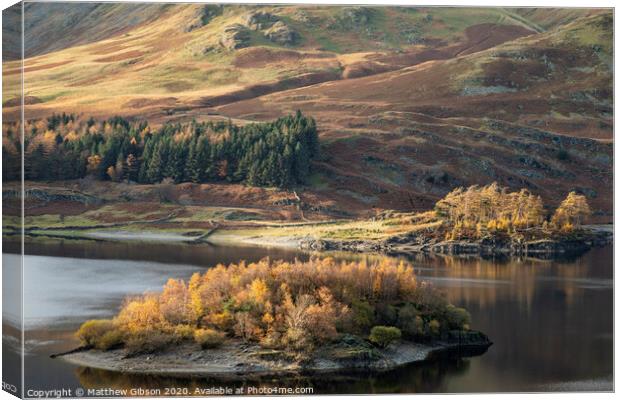 Stunning Autumn Fall landscape of Hawes Water with epic lighting and dramatic sunlight in Lake District Canvas Print by Matthew Gibson