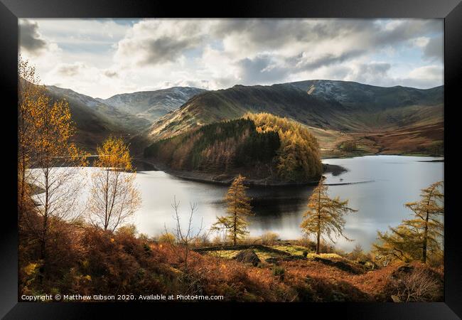 Stunning Autumn Fall landscape of Hawes Water with epic lighting and dramatic sunlight in Lake District Framed Print by Matthew Gibson