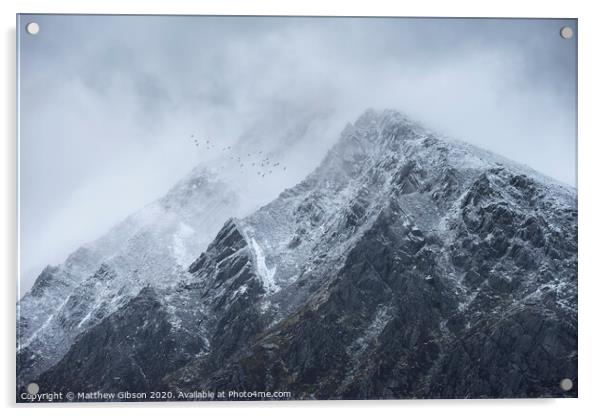 Stunning detail landscape images of snowcapped Pen Yr Ole Wen mountain in Snowdonia during dramatic moody Winter storm with birds flying high above Acrylic by Matthew Gibson