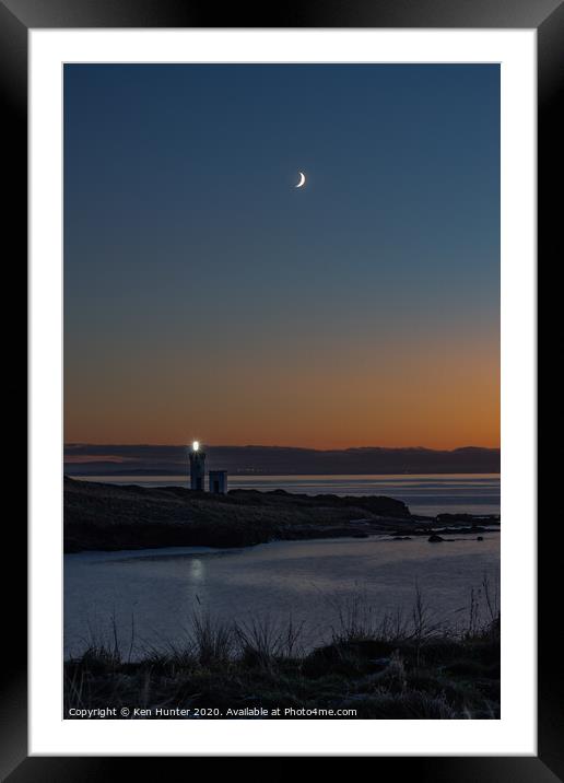 Lighthouse Beacon at Dusk on a Wintry Headland Framed Mounted Print by Ken Hunter