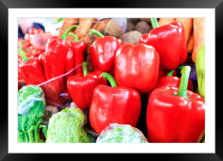 Large red sweet bell peppers on the background of other vegetables sold on the market Framed Mounted Print by Sergii Petruk