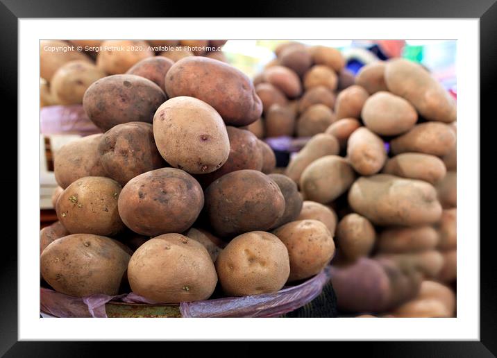 Dry potato tubers on the background of various other varieties in the blur. Framed Mounted Print by Sergii Petruk