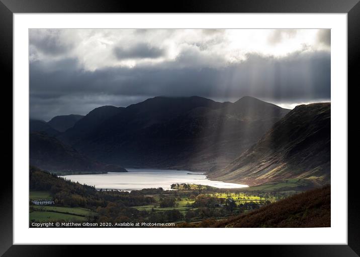 Majestic sun beams light up Crummock Water in epic Autumn Fall landscape image with Mellbreak and Grasmoor  Framed Mounted Print by Matthew Gibson