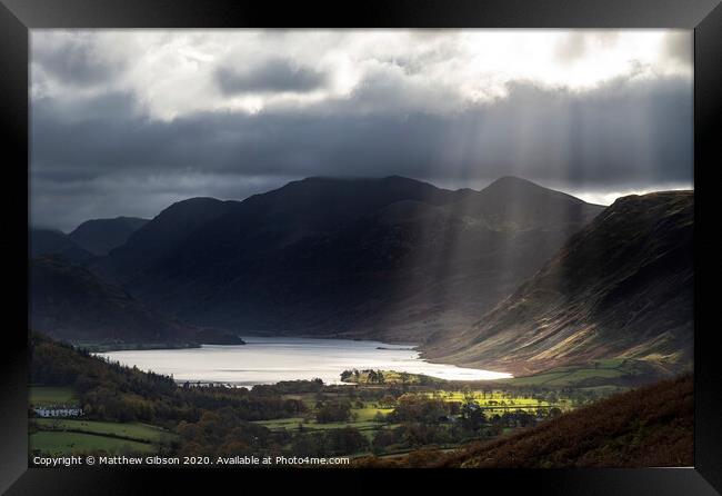 Majestic sun beams light up Crummock Water in epic Autumn Fall landscape image with Mellbreak and Grasmoor  Framed Print by Matthew Gibson