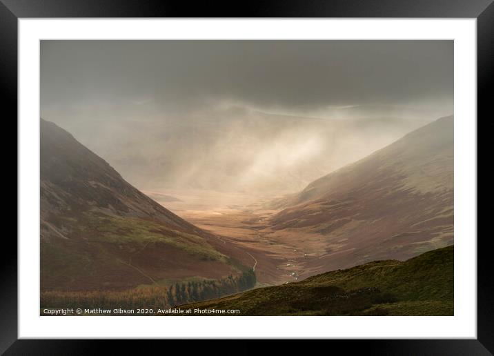 Stunning Autumn Fall landscape image of rain in valley in Lake District creating majestic lighting conditions Framed Mounted Print by Matthew Gibson