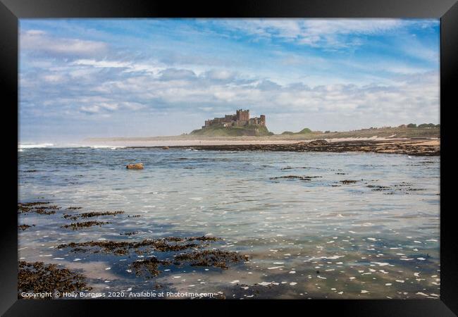 Cinematic Bamburgh Castle by the Shoreline Framed Print by Holly Burgess