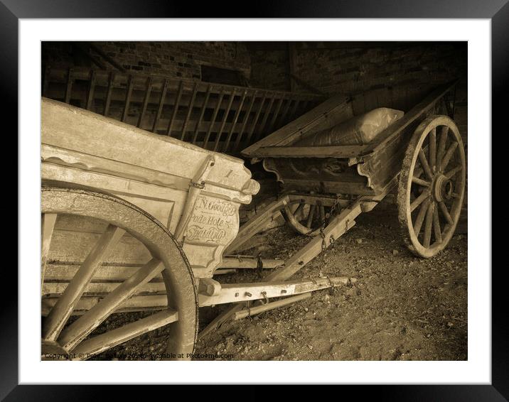 Victorian farm carts in a barn at Coggeshall, a village in Essex, UK Framed Mounted Print by Peter Bolton