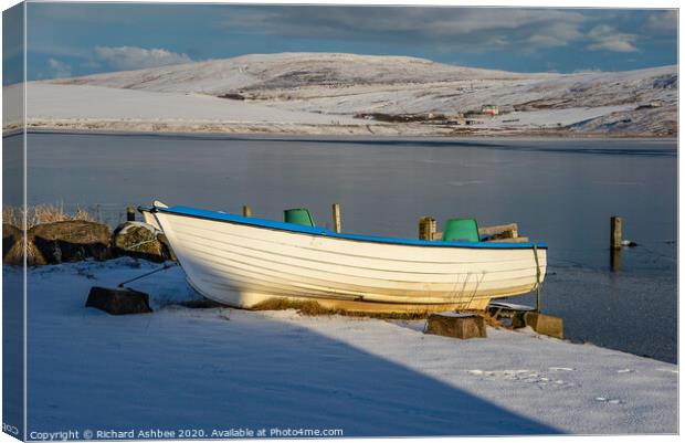 Shetland small white fishing boat in snow at Tingw Canvas Print by Richard Ashbee