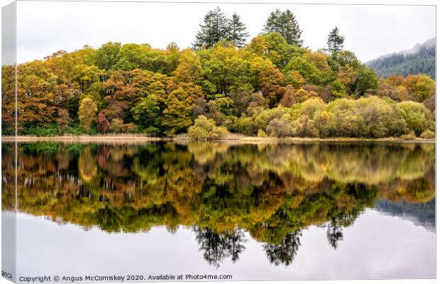 Colourful reflections on Loch Chon Canvas Print by Angus McComiskey