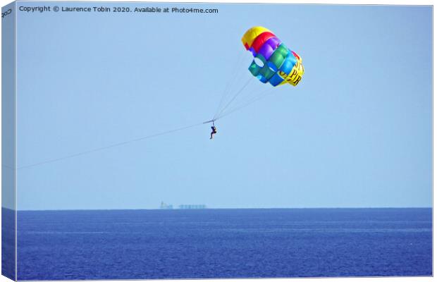 Parasailing above the sea at Biarritz, France Canvas Print by Laurence Tobin
