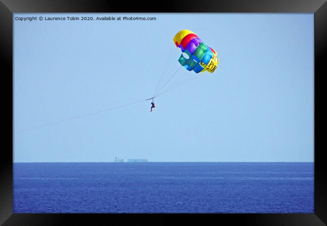 Parasailing above the sea at Biarritz, France Framed Print by Laurence Tobin