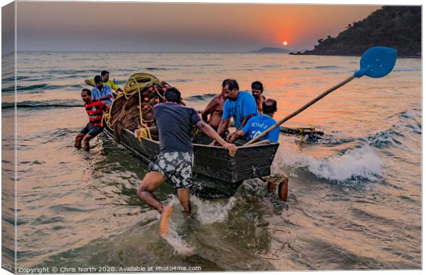 Goa, fisherman launching boat at sunset. Canvas Print by Chris North