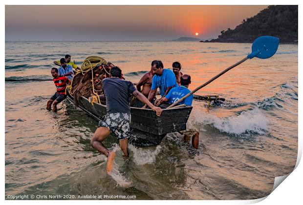 Goa, fisherman launching boat at sunset. Print by Chris North