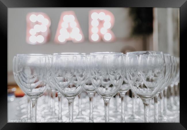 Empty glasses on a bar counter for drinking alcohol. Framed Print by Joaquin Corbalan