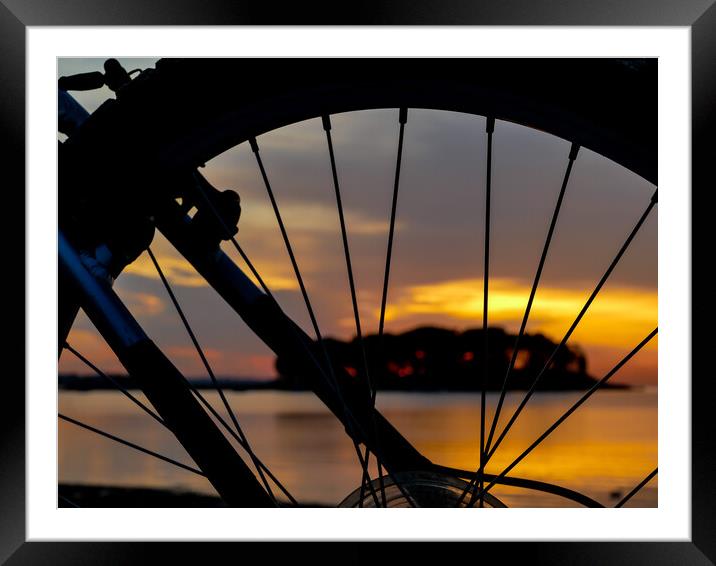 Wheel silhouette from bike and sunrise light  Framed Mounted Print by Miro V