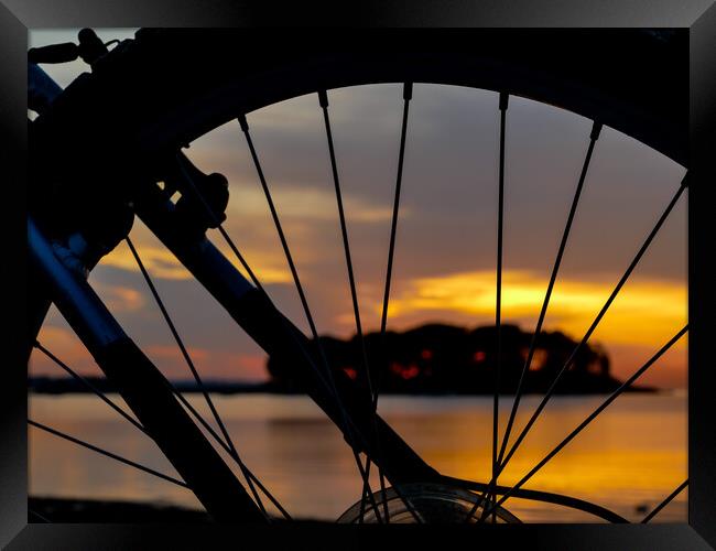 Wheel silhouette from bike and sunrise light  Framed Print by Miro V