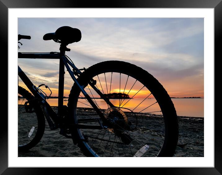Bike silhouette and sunrise light on beach Framed Mounted Print by Miro V