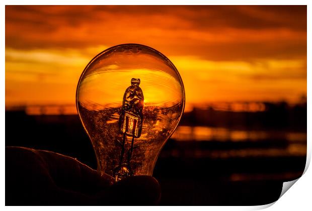 Light bulb in hand against colorful sunrise  Print by Miro V