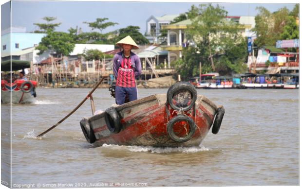 Small boat on the Mekong Delta at Tra On Canvas Print by Simon Marlow