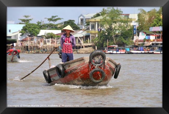 Small boat on the Mekong Delta at Tra On Framed Print by Simon Marlow