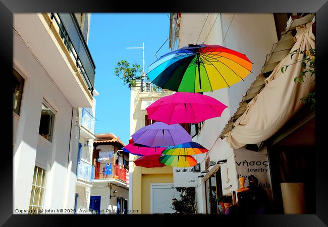 Colorful Parasols hanging in street at Skiathos Town in Greece.  Framed Print by john hill