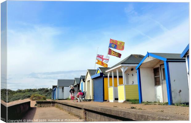 Beach hut flying the royal standard at Chapel point in Lincolnshire.  Canvas Print by john hill