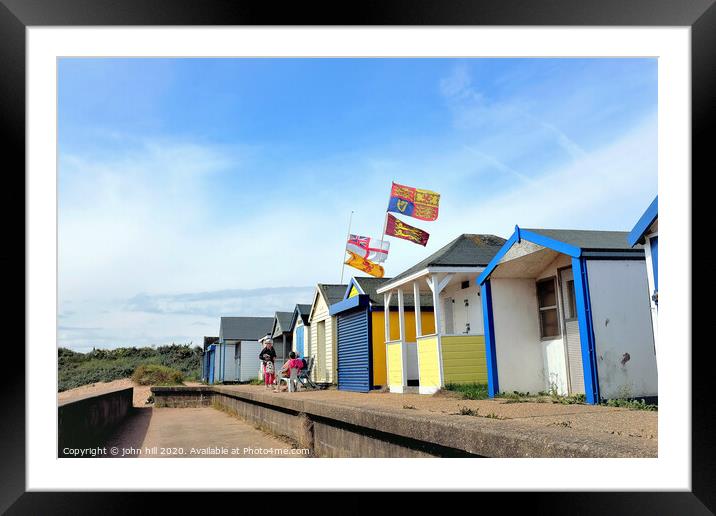 Beach hut flying the royal standard at Chapel point in Lincolnshire.  Framed Mounted Print by john hill