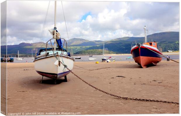 Beached boats  and mountains at Barmouth in Wales. Canvas Print by john hill
