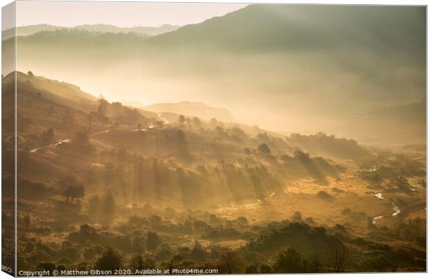 Beautiful Autumn Fall landscape sunrise in the Lake District with sun rays streaming through the fog into The Langdales valley Canvas Print by Matthew Gibson