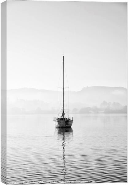 Stunning unplugged fine art landscape image of sailing yacht sitting still in calm lake water in Lake District during peaceful misty Autumn Fall sunrise Canvas Print by Matthew Gibson