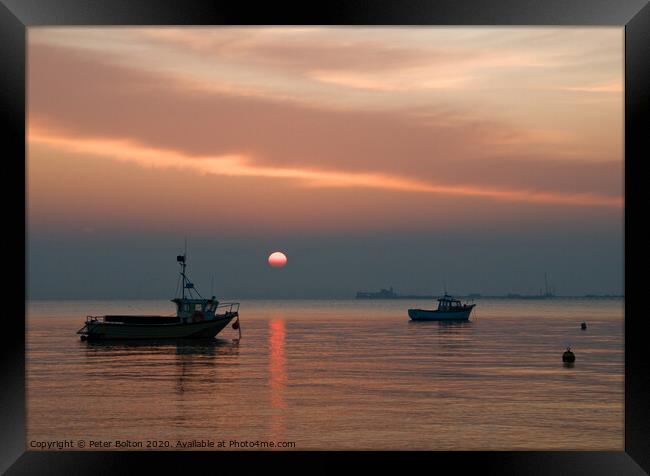 Setting sun above the pier at Southend on Sea, Essex, UK. Framed Print by Peter Bolton