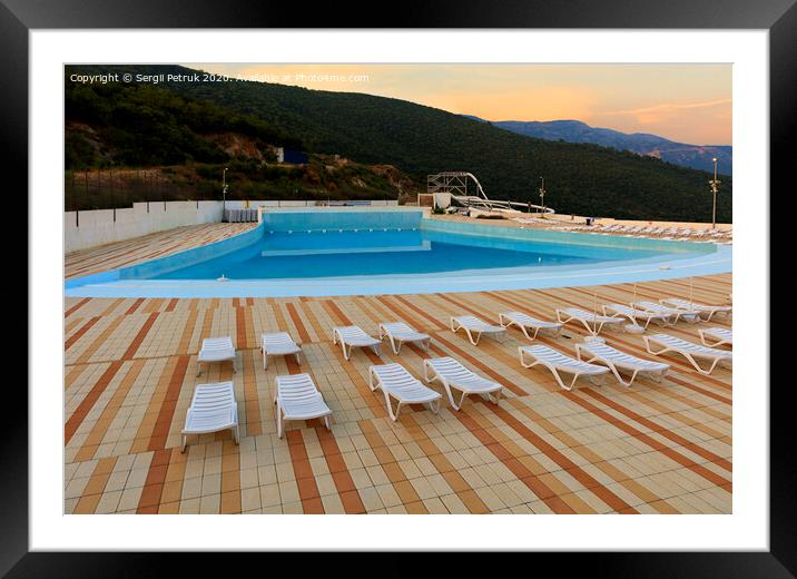 View of the empty pool, sun loungers and city water park in the morning at dawn. Framed Mounted Print by Sergii Petruk