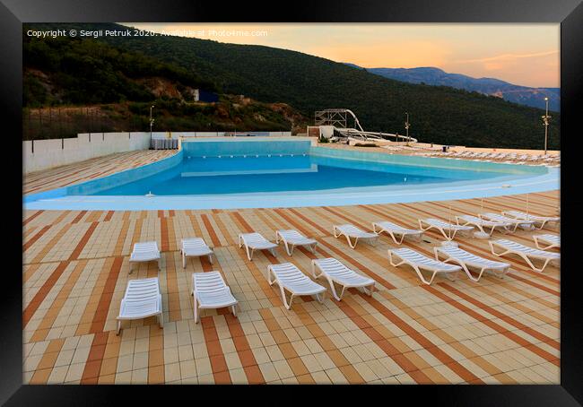 View of the empty pool, sun loungers and city water park in the morning at dawn. Framed Print by Sergii Petruk