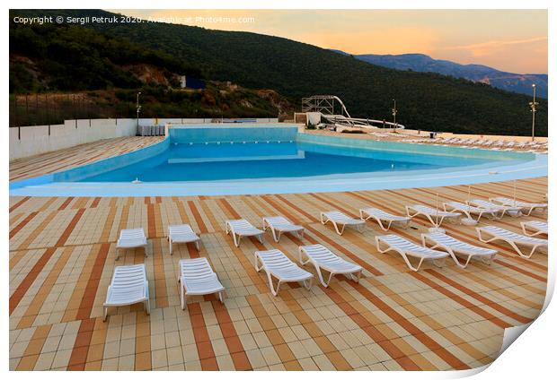 View of the empty pool, sun loungers and city water park in the morning at dawn. Print by Sergii Petruk