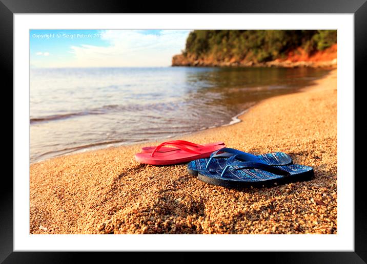 Beach slippers lie on a stone near the transparent sea Framed Mounted Print by Sergii Petruk