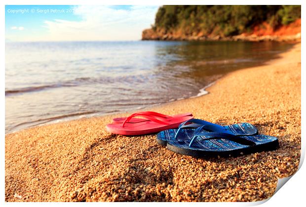 Beach slippers lie on a stone near the transparent sea Print by Sergii Petruk