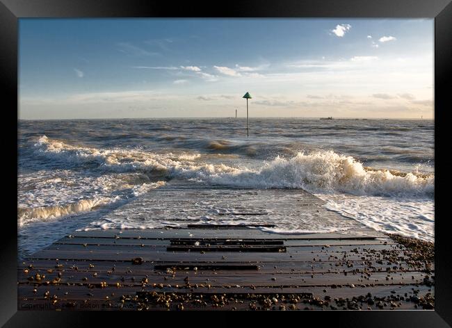Outgoing tide at Sailing club jetty, Thorpe Bay, Essex, UK. Framed Print by Peter Bolton