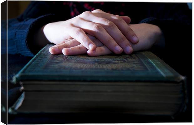 Hands on a bible Canvas Print by Nathan Wright
