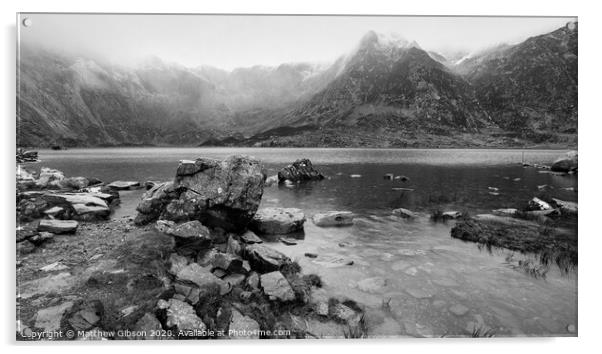 Beautiful moody Winter landscape image of Llyn Idwal and snowcapped Glyders Mountain Range in Snowdonia in black and white Acrylic by Matthew Gibson