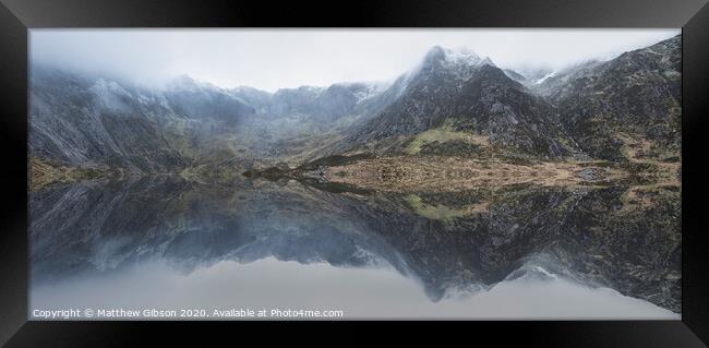 Beautiful moody Winter landscape image of Llyn Idwal and snowcapped Glyders Mountain Range in Snowdonia Framed Print by Matthew Gibson