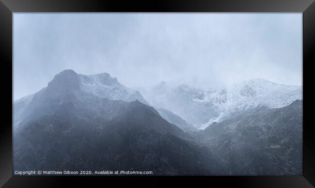 Stunning moody dramatic Winter landscape image of snowcapped Y Garn mountain in Snowdonia Framed Print by Matthew Gibson