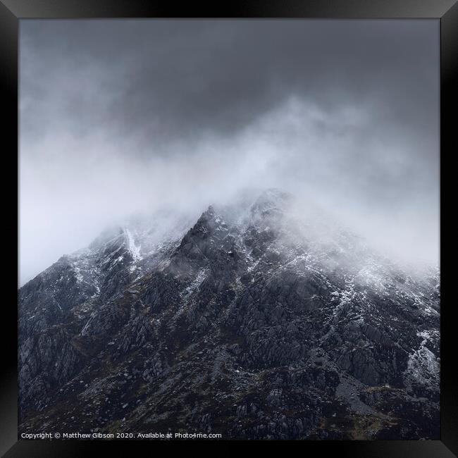Stunning detail landscape images of snowcapped Pen Yr Ole Wen mountain in Snowdonia during dramatic moody Winter storm Framed Print by Matthew Gibson